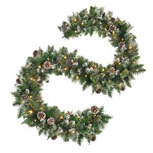 lot 1182 image: 9 FT Prelit Christmas Garland with Pine Cones, Artificial Snowy Pine Garland for Christmas 50 LED Battery Operated Warm Lights and Timer Xmas Garlands Decor Indoor Outdoor - Retail $50