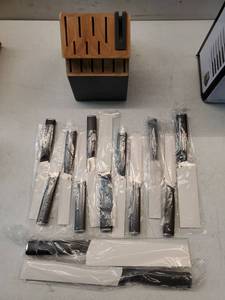 lot 26841 image: Kitchenaid 14 pc Cutlery Handcrafted Japanese Steel Comfortable Non-Slip Grip Building Knife Sharpener. Base is Damaged on the Side. - Retail $52