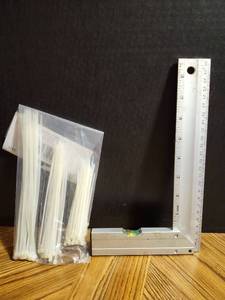 lot 305 image: Aluminum L-Square Ruler with White Cable Ties Bundle