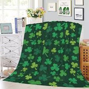 lot 4255 image: Green throw with a shamrock pattern. Approximately 45x54