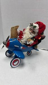 lot 1077 image: Santa Claus in Blue Toy Airplane Christmas Decoration