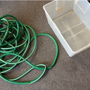 lot 1321 image: Garden hose with sprayer and tote missing lid