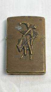 lot 14 image: Zippo Lighter with Embossed Cowboy Figurine Design