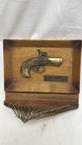 lot 135 image: Vintage Mississippi River Derringer Tie Rack with Metal Pistol Replica