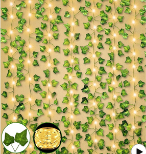 lot 2422 image: Fake Vines 12 Pack 84Ft Hanging Vines with 100 Lights Timer Large & Small Thick Green Leaves Faux Plants Greenery Garland String Lights Artificial Ivy for Bedroom Gardens Wall Room Home Decor - Retail $0