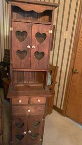 lot 1010 image: Wooden Cabinet with Heart Cutouts 66x17x10 located in basement