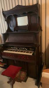 lot 1015 image: Geo. P. Bent Chicago Crown Pump Organ 78x44x23 with bench 19x14x13located in basement