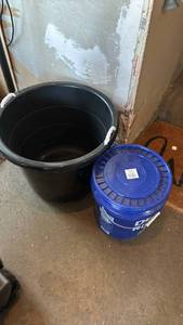 lot 2402 image: Large Black Plastic Storage Container with rope handles and a Blue 5 gal bucket with lid