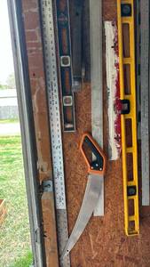 lot 3000 image: Metal Rulers, level, pry bars and a hand saw
