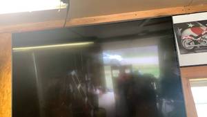 lot 3105 image: LG 50 inch Television with remote- needs to be removed from wall. Bring tools
