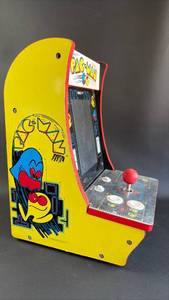 lot 35 image: Pac-Man Countercade, a compact, tabletop arcade machine designed for home use. Approximately 16 inches tall (Untested)