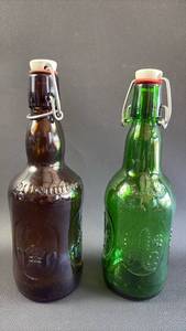 lot 64 image: FULL SIZE Ceramic Swing Top Beer Bottle Pair Green and Brown