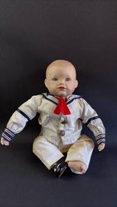 lot 71 image: Yolanda Bello Porcelain Baby Doll in Sailor Outfit (missing his hat)