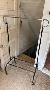 lot 5067 image: Rolling Garment Rack with Chrome and Black Metal Frame