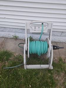 lot 7017 image: Garden Hose Reel Cart with Green Hose