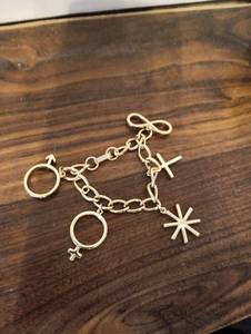 lot 10 image: Gold Tone Chain Bracelet with Cross and Star Charms