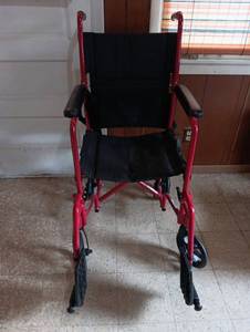 lot 136 image: Red Lightweight Transport Wheelchair with Black Seat