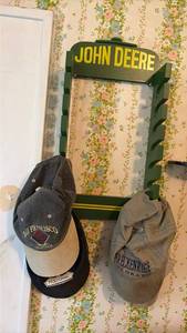 lot 3011 image: John Deere Wall Mount Hat Rack with Baseball Caps