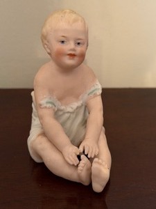 lot 109 image: Antique Bisque Porcelain Piano Baby Figurine
