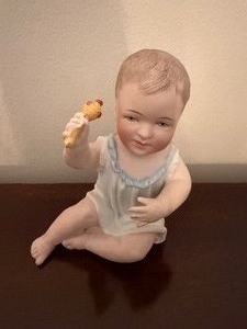 lot 110 image: Antique Bisque Porcelain Piano Baby Figurine