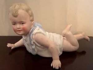 lot 111 image: Antique Bisque Porcelain Piano Baby Figurine