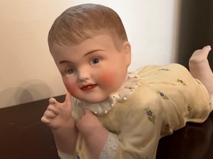 lot 112 image: Antique Bisque Porcelain Piano Baby Figurine