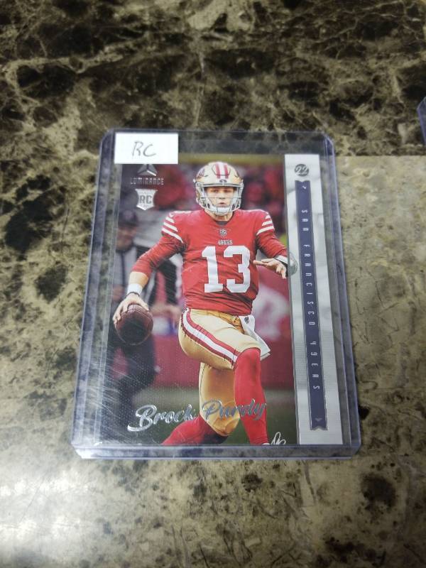 lot 1179 image: 2022 Panini Chronicles Luminance Football Brock Purdy San Francisco 49ers Rookie Card