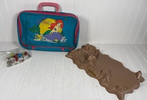 lot 330 image: Disney Little Mermaid Suitcase with Glass Marbles and Brontosaurus Building Plate