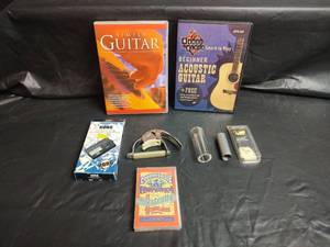 lot 30 image: Guitar Capo, Guitar Slides, Korg Chromatic Tuner and Learning Bundle