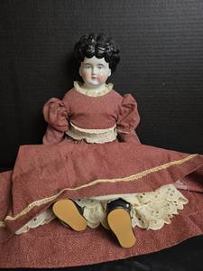 lot 467 image: Antique Porcelain Head Doll with Black Hair in Burgandy Dress- 20inch Doll