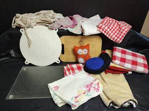 lot 676 image: Cutting Boards, Large Flour Sack, Hot Pads, Gloves, and Scouring Pads