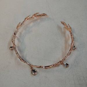 lot 26942 image: Rose Gold Leaf Crown with Crystal Drops - Delicate rose gold plated metal tiara featuring intricate leaf design with dangling crystal teardrops. Open back style with decorative botanical motifs and sparkling accent stones. - Retail $25