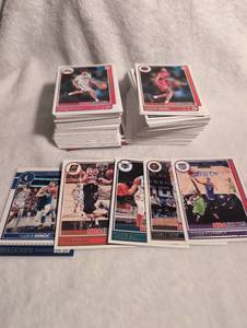 lot 3022 image: NBA Hoops Basketball Trading Card Collection - Includes Luka Doncic, Nikola Jonic, Tyrese Haliburton, Devin Booker, and LaMelo Ball -Approx 200 cards