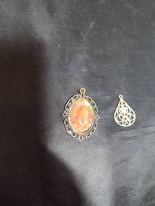 lot 118 image: Ornate Oval Opal Pendant with Filigree Frame