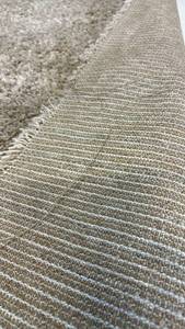 Tan 7"x10" Shag Area Rug.