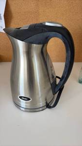 lot 60395 image: Oster Stainless Steel Electric Kettle with Black Handle - Retail $25