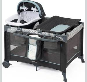 lot 17894 image: 5 in 1 Multifunctional Pack and Play,Qutanix Foldable Baby Crib with Bassinets,Changing Table,Newborn Napper with Canopy,Diaper Stacker,Baby Playpen for Babies and Toddlers - Retail $159