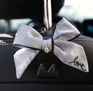 lot 2628 image: Decorative Bow Car Clip Purse Holder