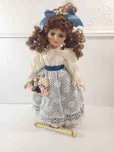 lot 175 image: Collectors Choice Porcelain Doll with Auburn Curls and Blue Dress