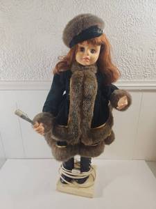 lot 176 image: Collectible Doll in Winter Coat with Fur Trim and Musical Base Telco