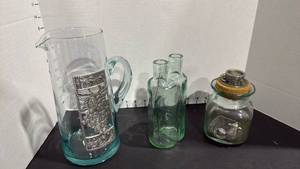 lot 4004 image: Green glass nesting bottles, Seagull pewter jar with cork top and pitcher. Pitcher has crack-great display or faux floral pitcher