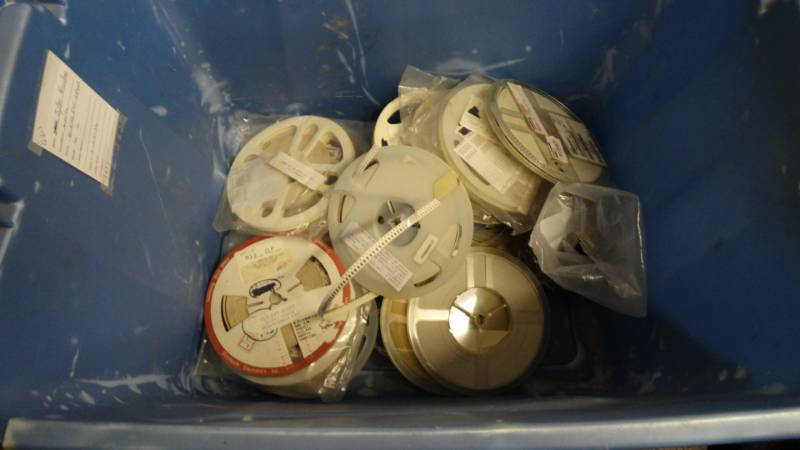 lot 10904 image: Tote of chip capacitors reels.