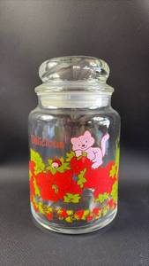 lot 87 image: Strawberry Shortcake Themed Glass Storage Jar with Lid Featuring Custard the Cat Approximately 7 Inches Tall