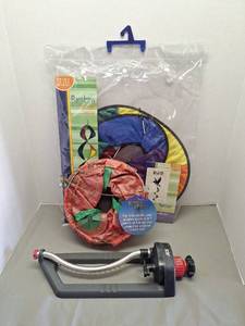 lot 123 image: NEW Rainbow DNA Helix Wind Twister Garden Spinner, NEW Topsy Turvy, and Sprinkler (other items pictured in background not included)