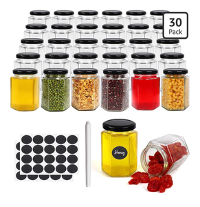 lot 3526 image: Betrome 6oz Hexagon Glass Jars, 30 Pack with Black Lids - 180ml Clear Glass Canning Jars for Honey, Spices, Jams, Shower Favors, Wedding Favors and Craft - Includes 1 Pen and Labels - Retail $0
