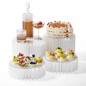 lot 8683 image: HeiMma 4 Pack Buffet Risers, FOLDABLE Accordion Food Display Risers for Dessert Table,Dessert Table Display Set, White Cardboard Cylinder Cake Cupcake Stands for Party, Multi-height, 12in Round - Retail $27