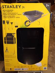 lot 1043 image: Stanley Jr. Kids Wheelbarrow Set �� 6-Piece Durable Toddler Wheelbarrow & Garden Tools �� Child Outdoor Toy for Ages 3 �� Fun, Educational Backyard Play with Apron, Gloves & Tools - Retail $70