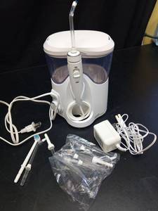 lot 1082 image: Waterpik Water Flosser with Accessories and Travel Case - Retail $45