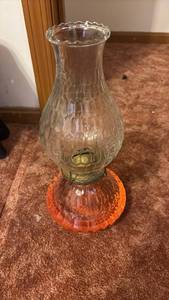 lot 60688 image: Glass Oil Lamp with Orange Base and Clear Chimney - Retail $15