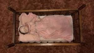 lot 60691 image: Porcelain Baby Doll in Pink Dress with Wooden Cradle - Retail $25